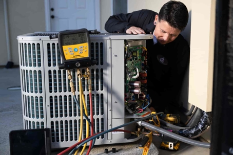 technician working on AC unit