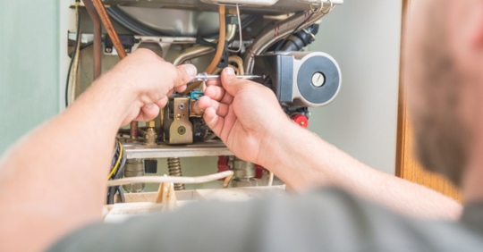 man performing a furnace repair