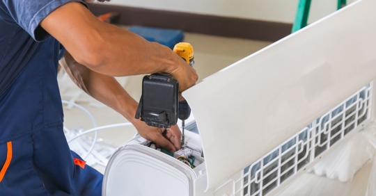 technician installing new AC unit